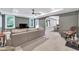 Spacious basement living area with ample seating, natural light and an adjoining game room at 4045 Bridle Ridge Dr, Suwanee, GA 30024
