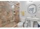 This bathroom has a tiled shower with a glass door, a pedestal sink, and modern fixtures at 4045 Bridle Ridge Dr, Suwanee, GA 30024