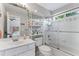 Well-lit bathroom with a shower over tub, vanity, and ample storage shelving at 4045 Bridle Ridge Dr, Suwanee, GA 30024