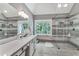 Modern bathroom featuring a walk-in shower with gray marble, dual shower heads and a large window at 4045 Bridle Ridge Dr, Suwanee, GA 30024