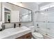 Well-lit bathroom with white marble countertop, modern vanity, and glass-enclosed shower/tub combo at 4045 Bridle Ridge Dr, Suwanee, GA 30024