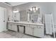 Bright bathroom with double vanity, modern lighting, and a barn door for added style at 4045 Bridle Ridge Dr, Suwanee, GA 30024