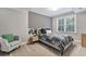 Comfortable bedroom features a queen bed, chair, and a window offering serene views at 4045 Bridle Ridge Dr, Suwanee, GA 30024