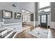 Elegant foyer with hardwood floors, a modern entry door, and decorative mirrors on the wall at 4045 Bridle Ridge Dr, Suwanee, GA 30024