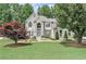 Charming two-story home with a well-manicured lawn, mature trees, and elegant landscaping at 4045 Bridle Ridge Dr, Suwanee, GA 30024