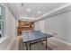 An inviting game room features a ping pong table and a built-in wet bar, perfect for entertainment at 4045 Bridle Ridge Dr, Suwanee, GA 30024