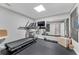 Well-lit gym space includes a treadmill, weights, mirror, and ample room for exercise at 4045 Bridle Ridge Dr, Suwanee, GA 30024