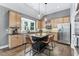 Gourmet kitchen boasts stainless appliances, light wood cabinets and a center island with bar seating at 4045 Bridle Ridge Dr, Suwanee, GA 30024