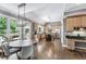 Bright eat-in kitchen with stainless steel appliances and natural wood cabinets; dining area leads to outdoor porch at 4045 Bridle Ridge Dr, Suwanee, GA 30024