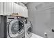 Functional laundry room with updated washer/dryer and cabinet space for storage at 4045 Bridle Ridge Dr, Suwanee, GA 30024