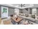 A welcoming living room features a plush sofa, ceiling fan, and convenient access to the outdoors at 4045 Bridle Ridge Dr, Suwanee, GA 30024