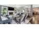 Cozy living room with a fireplace, comfortable sofas, and a view into the kitchen area at 4045 Bridle Ridge Dr, Suwanee, GA 30024