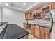 Stylish wet bar with wood cabinetry, granite countertops, stainless steel sink, and wine storage at 4045 Bridle Ridge Dr, Suwanee, GA 30024
