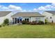 Inviting patio with outdoor furniture and beautiful landscaping create the perfect outdoor oasis at 5744 Cypress Bluff Ln, Hoschton, GA 30548