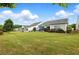 Expansive backyard featuring a well-maintained lawn, patio area, and mature landscaping at 5744 Cypress Bluff Ln, Hoschton, GA 30548