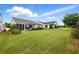 Spacious backyard featuring lush green grass, a patio with furniture, and mature trees at 5744 Cypress Bluff Ln, Hoschton, GA 30548