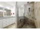 This bathroom features a shower stall, double sinks, vanity, and tile floors at 5744 Cypress Bluff Ln, Hoschton, GA 30548