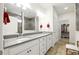 This bathroom features a double sink vanity, walk-in shower, and tile floors at 5744 Cypress Bluff Ln, Hoschton, GA 30548