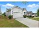 Well-maintained home with a two-car garage, driveway, and a neatly manicured lawn at 5744 Cypress Bluff Ln, Hoschton, GA 30548