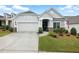 Charming home featuring a two-car garage, well-manicured lawn, and inviting front porch at 5744 Cypress Bluff Ln, Hoschton, GA 30548