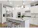 Bright open kitchen features granite countertops, stainless steel appliances and bar stool seating at 5744 Cypress Bluff Ln, Hoschton, GA 30548