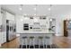 Open kitchen features granite countertops, stainless steel appliances and bar stool seating at 5744 Cypress Bluff Ln, Hoschton, GA 30548