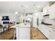 Modern kitchen features white cabinets, granite countertops, stainless steel appliances, and a center island with seating at 5744 Cypress Bluff Ln, Hoschton, GA 30548