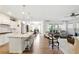 Open concept living area with hardwood floors, natural light, and modern decor at 5744 Cypress Bluff Ln, Hoschton, GA 30548