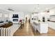 Spacious living room flows into a modern kitchen with granite countertops and stainless steel appliances at 5744 Cypress Bluff Ln, Hoschton, GA 30548