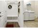 Convenient mudroom with bench, coat hooks, and adjacent laundry area at 5744 Cypress Bluff Ln, Hoschton, GA 30548