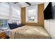 Comfortable bedroom with natural light, a ceiling fan, and a mounted TV at 61 16Th Ne St # 4, Atlanta, GA 30309