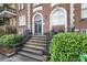 Building entrance featuring an arched doorway and manicured landscaping and staircase at 61 16Th Ne St # 4, Atlanta, GA 30309