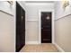 Hallway featuring a tiled floor and paneled walls at 61 16Th Ne St # 4, Atlanta, GA 30309