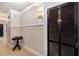 Hallway featuring paneled walls, tiled floor and vintage lighting at 61 16Th Ne St # 4, Atlanta, GA 30309