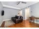 Cozy living room features a comfortable leather sofa, hardwood floors, and a ceiling fan at 61 16Th Ne St # 4, Atlanta, GA 30309