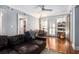 Bright living room with hardwood floors, a sofa, bookshelves, and a guitar at 61 16Th Ne St # 4, Atlanta, GA 30309