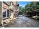 Apartment rear with parking, featuring brick and a covered parking area at 61 16Th Ne St # 4, Atlanta, GA 30309
