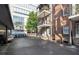 Apartment rear with parking, featuring brick and a covered parking area at 61 16Th Ne St # 4, Atlanta, GA 30309
