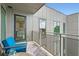 This outdoor balcony shows comfortable blue chairs and a view of the neighborhood at 775 Juniper Ne St # 612, Atlanta, GA 30308