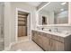 Modern bathroom featuring double sinks, a large mirror, ample storage, and a separate shower area at 775 Juniper Ne St # 612, Atlanta, GA 30308
