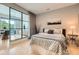 A cozy bedroom features hardwood floors, modern decor, and access to an outdoor balcony through steel-framed glass doors at 775 Juniper Ne St # 612, Atlanta, GA 30308