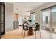 Bright dining area with a modern table, access to outdoor space, and open concept design at 775 Juniper Ne St # 612, Atlanta, GA 30308