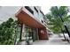 This building features modern architecture and lush greenery surrounding the entrance, complemented by blue skies at 775 Juniper Ne St # 612, Atlanta, GA 30308