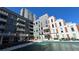 Modern condo buildings with balconies, featuring a pool area, outdoor seating, and well-maintained landscaping at 775 Juniper Ne St # 612, Atlanta, GA 30308