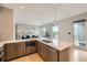 Stylish kitchen featuring wood cabinets, a central island, stainless steel appliances, and access to an outdoor deck at 775 Juniper Ne St # 612, Atlanta, GA 30308