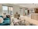 Open-concept living area with modern decor, light hardwood floors, blue sofa, and views of the city at 775 Juniper Ne St # 612, Atlanta, GA 30308