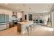 Open-concept design connects kitchen and living, flooded with light, with modern island and stylish teal sofa at 775 Juniper Ne St # 612, Atlanta, GA 30308