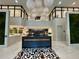 This modern lobby features eye-catching decor, a geometric floor pattern, a reception desk and ambient lighting at 775 Juniper Ne St # 612, Atlanta, GA 30308
