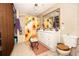 Full bathroom featuring tile flooring, decorative sunflower shower curtain, stool, vanity, toilet and mirror at 9155 Nesbit Ferry Rd, Alpharetta, GA 30022