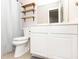 Bathroom featuring a modern toilet, vanity with cabinets, and a shower with a curtain at 9155 Nesbit Ferry Rd, Alpharetta, GA 30022